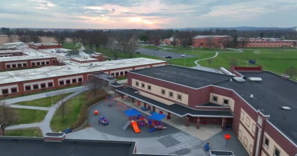 American School Buildings Sunrise Recess Playground Equipment Students Aerial View — Vídeo de Stock