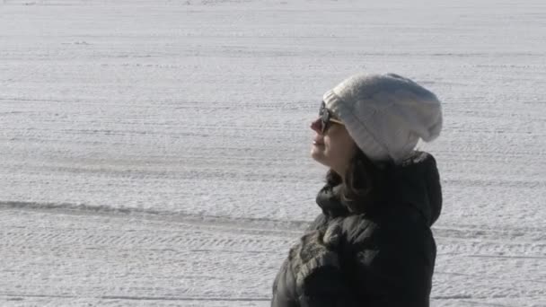 Beautiful Woman Enjoys Winter Sun Wearing Sunglasses Cap — Stockvideo