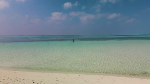 Man Stands Turquoise Water Stormy Sky Camera Moves Smoothly — Stockvideo