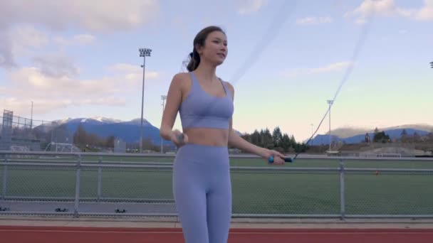 Mixed Race Woman Jump Roping Outdoors Track Field Slow Motion — Stock Video