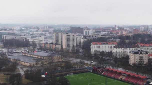 Aerial Tilt Solna Skyline Soccer Pitch — Vídeos de Stock