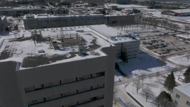 Drone Ascending Snowy Rooftop Revealing Laval University Building Quebec Canada — 비디오
