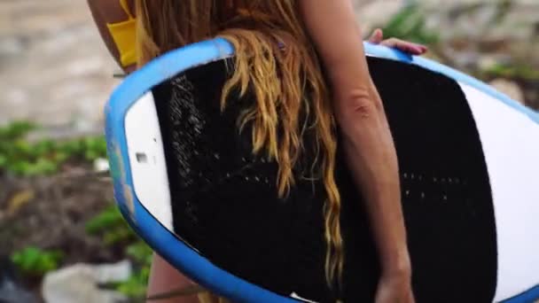 Woman Yellow Bikini Surfboard Looking Beach Back View Gimbal Tilt — Stockvideo