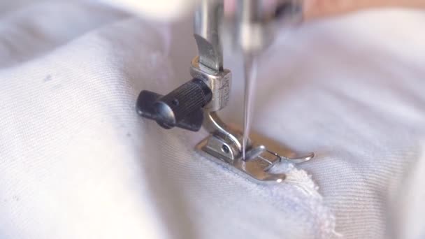 Seamster Hands Gently Pulling White Cloth Backwards While Sewing Stitches — Vídeo de stock
