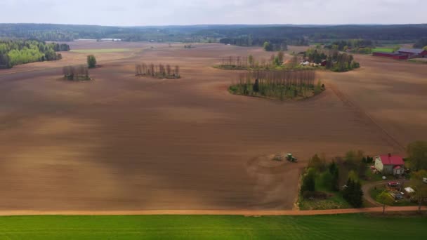 Aerial View Tractor Plowing Circles Nordic Fields Tracking Drone Shot — Vídeos de Stock