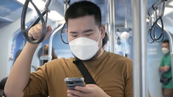 Asian Man Using Smartphone While Public Subway Transportation — стоковое видео