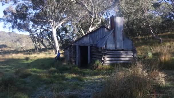 Young Boy Sits Old Wooden Heritage Hut Australian Bush Smoke — ストック動画