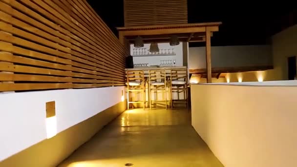 Pov Walking Backwards Bar Terrace Hotel White Wood Decor Night — стоковое видео
