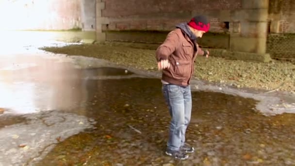 Man Walking Frozen Water Dances — Vídeos de Stock