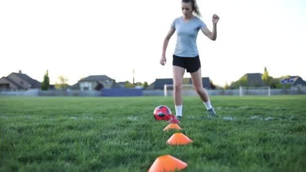 Girl Practicing Soccer Dribbling Orange Cones Grass — Stockvideo