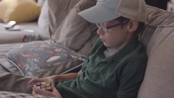 Boy Sitting Couch Plays Cube Puzzle Game — Stock videók