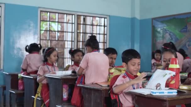 Young Indian Teacher Monitors Her Elementary Students Reading Activity — Stockvideo