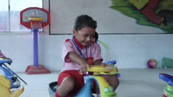Young Indian Students Playroom Smiling Riding Cars — Vídeo de Stock