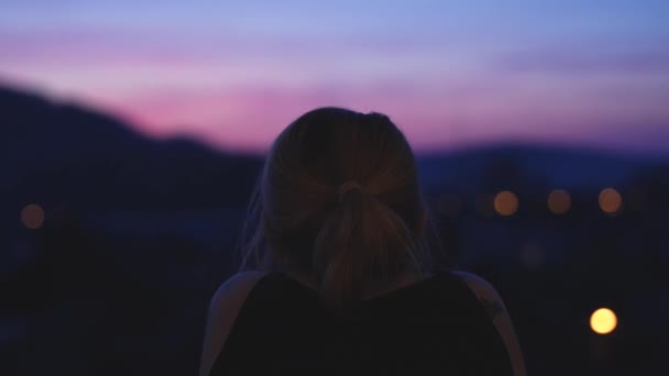 Girl Looking Out Window Enjoys Purple Sunset — Vídeo de Stock