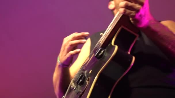 Guitarist Playing Live Concert Strums Them Punches Air Colourful Background — Stockvideo