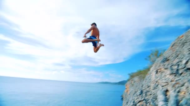 Giovane Saltando Una Scogliera Nel Blu Del Mar Dei Caraibi — Video Stock