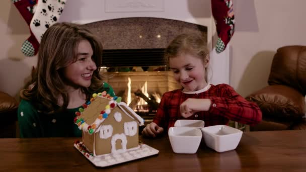 Mother Daughter Decorating Gingerbread House Christmas Fireplace — Stock Video