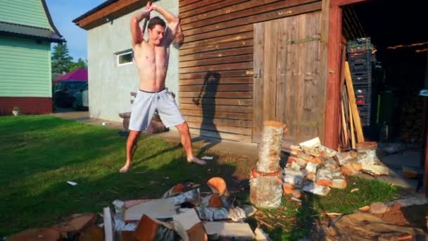 Young Man Splitting Wood Axe Slow Motion — Stock Video