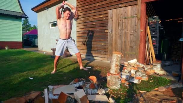 Young Man Splitting Wood Axe Slow Motion — Stock video