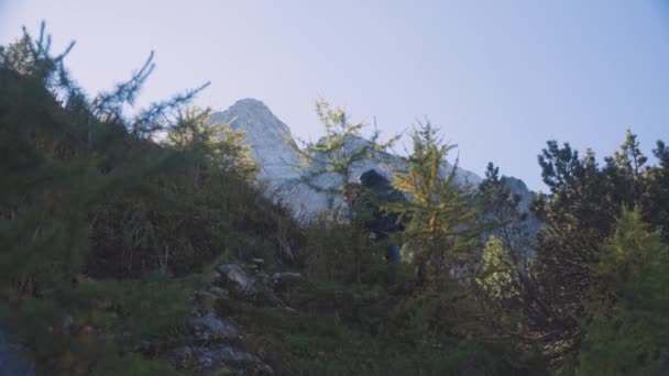 Backpacker Climbs Hill Reaches Top Low Angle Slow Motion Shot — Vídeo de Stock