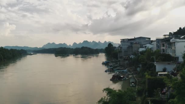 中国の曇りの日の洪水による川 背景にカルスト山脈 — ストック動画