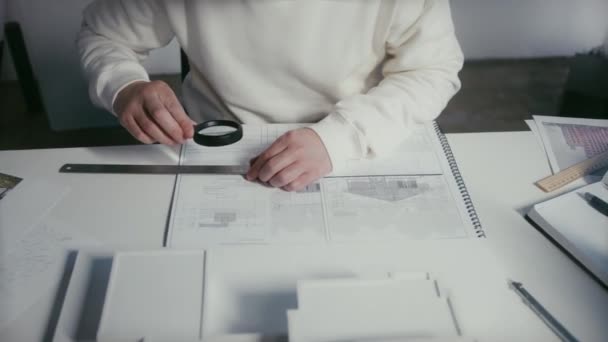 Man Measuring Looking Closely Blueprints Using Ruler Converging Lens — Videoclip de stoc