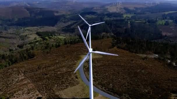 Two Wind Turbines Lined Spinning Blades Mountains Small Green Forests — Video Stock