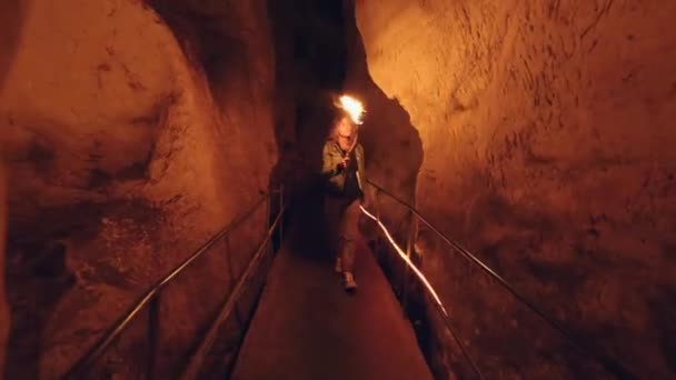 Female Traveler Exploring Cave Fiery Torch Hand Slow Motion Primitive — Video Stock