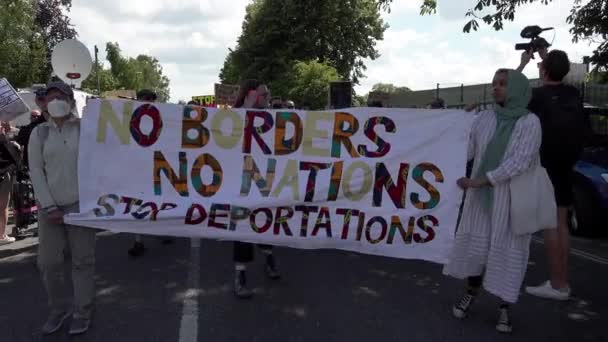 Protestors Walk Banner Reads Borders Nations Stop Deportations Protest First — Stock video