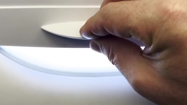 Man Hand Opens Aircraft Window Shade Which Airplane Wing Clouds — Stock Video