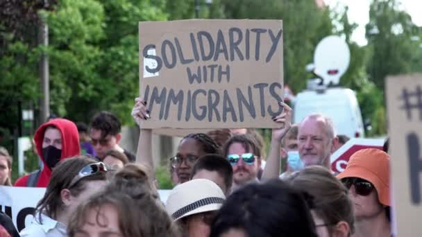Protestor Holds Handmade Cardboard Placards Reads Solidarity Migrants Protest First — Wideo stockowe