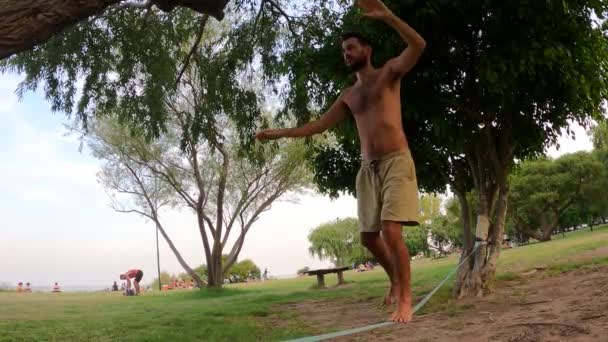 Hispanic Man Balances Slack Line Park Slow Motion — Video