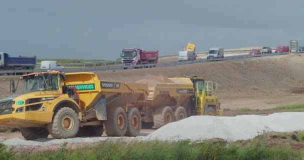 Heavy Dump Trucks Taking Soil Away Next Busy Roadway Development — Vídeos de Stock