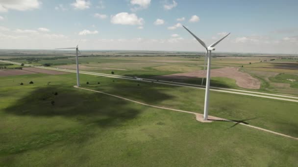 Two Wind Turbines Field Adjacent State Highway Light Traffic Aerial — Vídeo de Stock