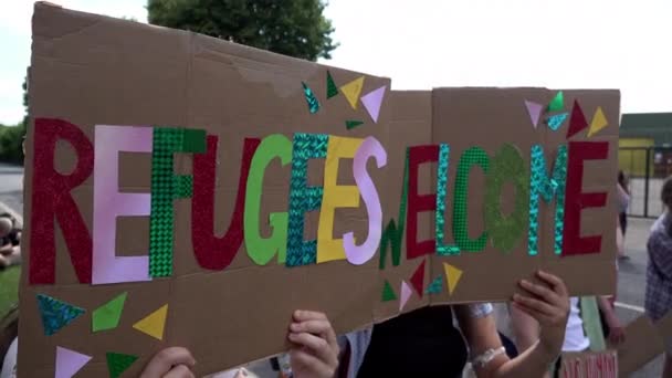 Two Handmade Cardboard Placards Read Refugees Welcome Protest First Flight — Stockvideo