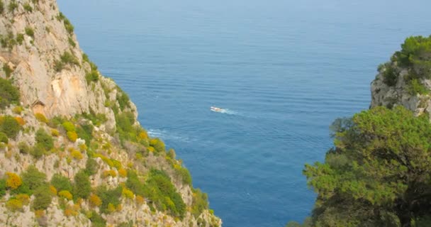 Aerial View Motor Boat Distance Visible Green Rocky Sea Cliffs — Stock Video