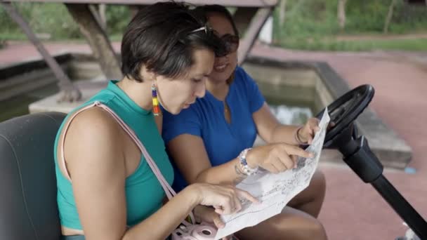 Two Women Looking Map Sitting Golf Cart Ancient City Park — Stock Video