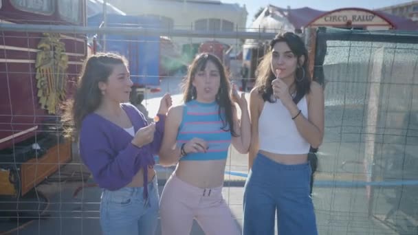 Three Happy Girls Lollipops Stand Joke Metal Fence — Vídeo de stock