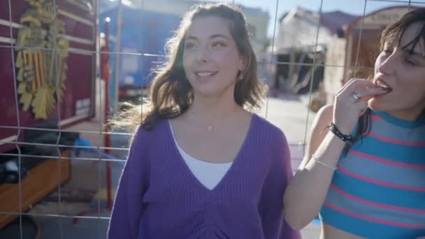 Two Girls Sunlight Metal Fence Laughing Eating Close Slomo — Stok video