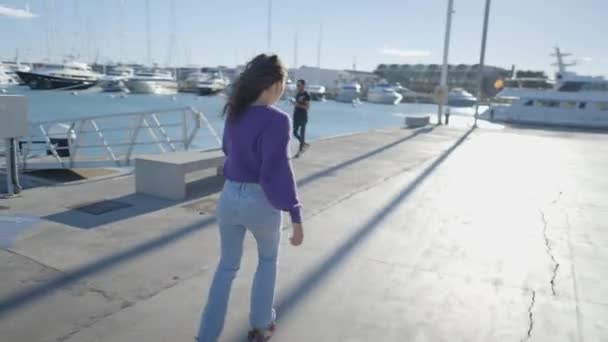 Lone Dark Haired Girl Roller Skates Sunlight Boats Harbor — Stockvideo