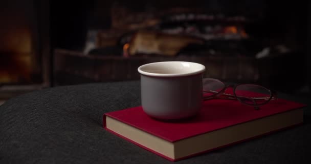 Relaxing Scene Book Coffee Cup Glasses Table Fireplace Background — Vídeo de Stock