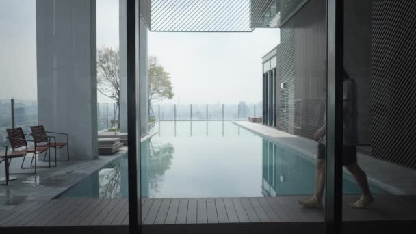 Man Walking Wooden Pool Deck Luxury Hotel Rooftop Medium Shot — 图库视频影像