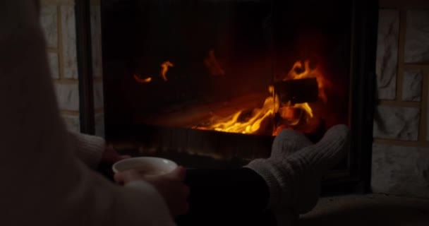 Woman Coffee Cup Feet Socks Fireplace — стоковое видео