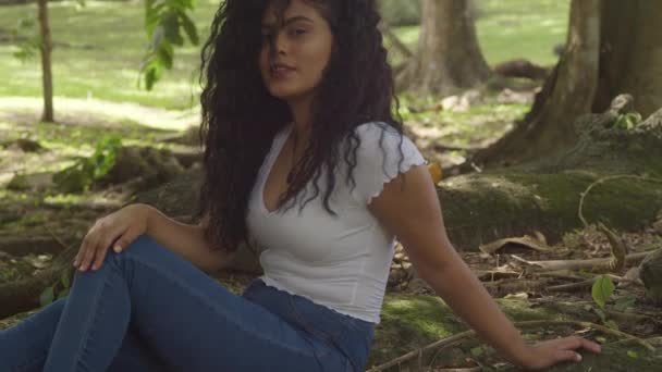 Hispanic Model Sitting Large Tree Trunk While Playing Her Hair — ストック動画