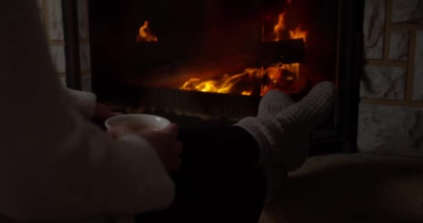 Close Person Sitting Next Fireplace While Sipping Hot Drink — Stockvideo