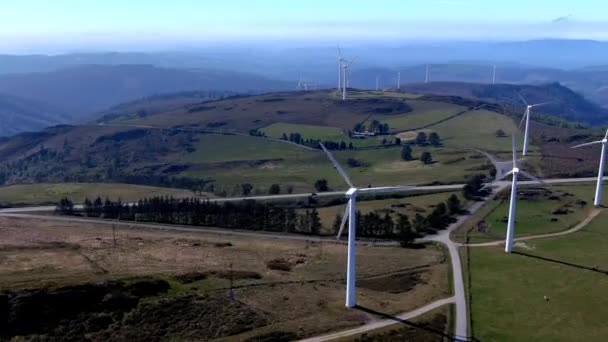 Wind Turbines Spinning Mountains Cattle Grazing Nearby Road Traveling Car — Stockvideo