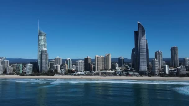 Large Modern Buildings Rising Calm Ocean Distant Mountain View Unique — Vídeo de Stock