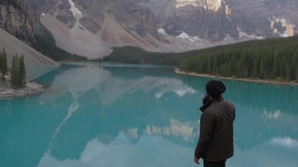 Ένας Ταξιδιωτικός Φωτογράφος Στέκεται Κοντά Μια Μπλε Λίμνη Στο Banff — Αρχείο Βίντεο