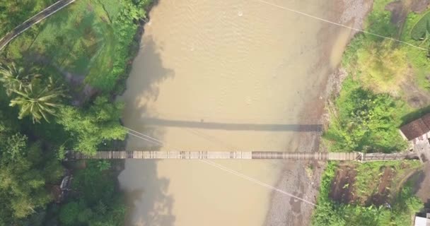Overhead Drone Shot Suspension Bridge River Morning Sun Ray Central — Vídeos de Stock