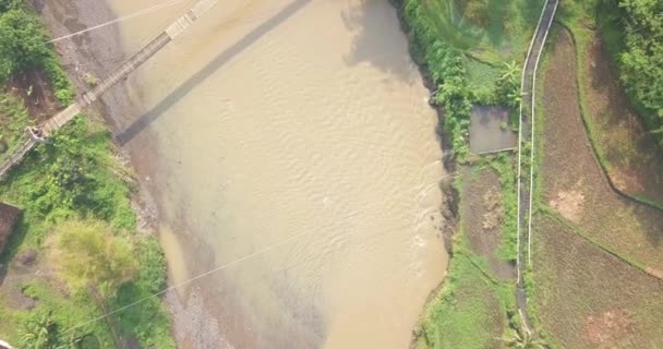 Overhead Drone Shot Suspension Bridge River Motorcycle Crossing Slightly Foggy — Vídeo de stock